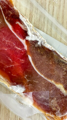 Crimson streaks of marbled cured meat evoke Spanish Jamon lust with gastronomic allure, perfect for Tapas Day festivities