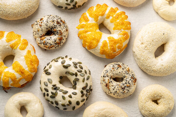Raw assorted bagels flat lay before baking