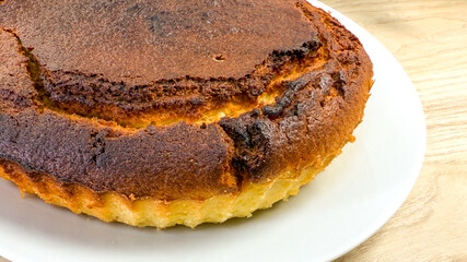 Golden-brown Basque cheesecake, rustic dessert perfection, charred edges whisper Candlemas joy, embodying culinary magic, embracing simplicity