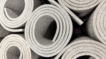 Swirled silver yoga mats unfurl like metallic scrolls, evoking Zen tranquility, International Yoga Day, and minimalist meditation retreats