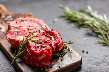 Raw beef meat on a wooden cutting board