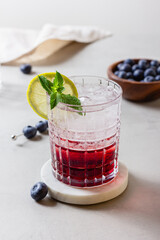 Cocktail with ice in a glass on marble