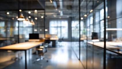 Blurred modern office interior with glass partitions and warm lighting bokeh.