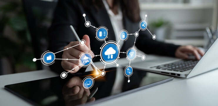 A business professional engages with cloud technology through a digital tablet in a modern office, showcasing the integration of innovative solutions and data analysis. Tessel