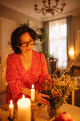 A woman is setting the table for Christmas dinner