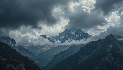 Mountain range under a cloudy sky with snowy peaks