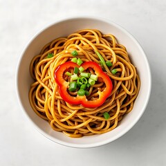 Bowl of delicious noodles with red pepper and scallions