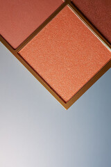Fototapeta premium Warm orange and coral eyeshadow palette with glitter texture accentuating cosmetic beauty and make up products