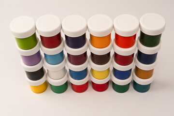 Gouache colorful paints set. Jars of gouache paint isolated on a white background.