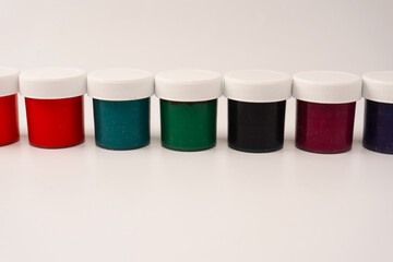 Gouache colorful paints set. Jars of gouache paint isolated on a white background.