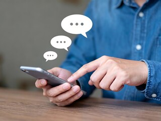 Person using a smartphone with speech bubbles representing communication and online messaging for social media and digital interaction