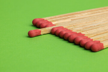 large matches on a green background