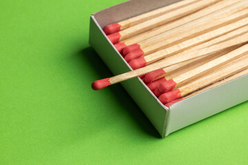 large matches on a green background