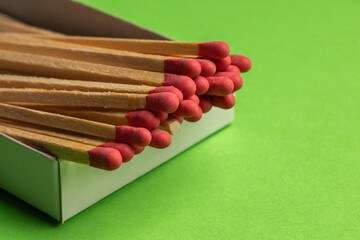 large matches on a green background