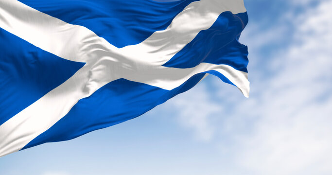 The flag of Scotland waving in the wind on a clear day