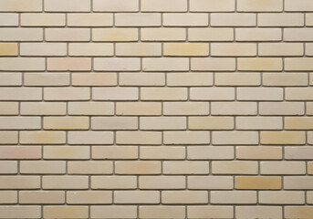 Fototapeta premium A close-up shot of a beige brick wall, perfect for textures and backgrounds. The bricks are arranged in a classic pattern, showcasing the detail and texture of the material. 