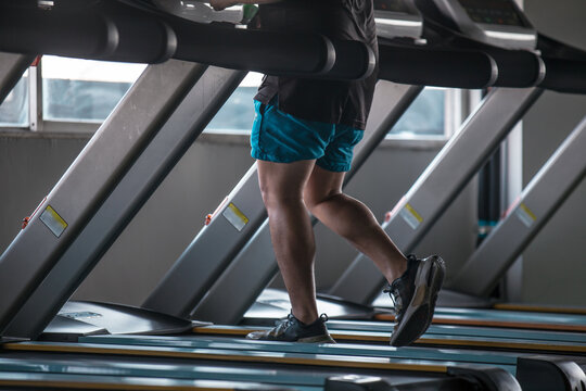 Man Jogging on Treadmill in Gym daytime indoors