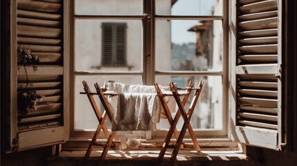 Natural Light Shines Through Open Window with Laundry Drying on Rack, Capturing the Essence of Cozy Indoor Moments and Tranquil Living Spaces