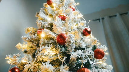 Christmas tree with red lights and white snowy branches tilt up