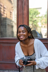 Portrait of happy young woman with vintage camera