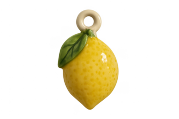 Ceramic lemon ornament with green leaf on transparent background