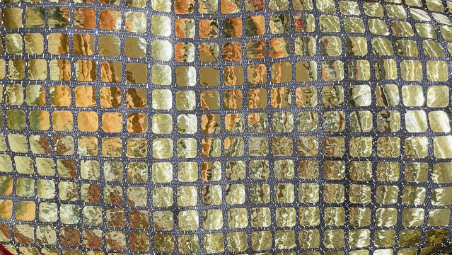 Gold and silver sequin fabric macro background. Shimmering mosaic pattern for luxury party and fashion design