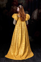 A red-haired woman wearing a historically styled gold gown with puffy sleeves
