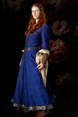 Medieval or high fantasy woman wearing a blue silk dress with hanging gold sleeves