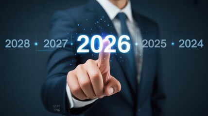 A businessman's finger pointing at the number 2026, representing future planning and business strategies. The overall mood suggests a focus on the future and financial forecasting.