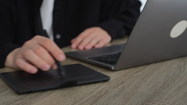 An office worker works on a laptop and uses a digital graphics tablet.
Digital artist or logo illustrator for brands and businesses.
Business, illustration, stylus, business, drawing, art