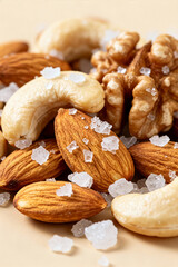 Mixed nuts with salt on a light surface ready for snacking at any time of day