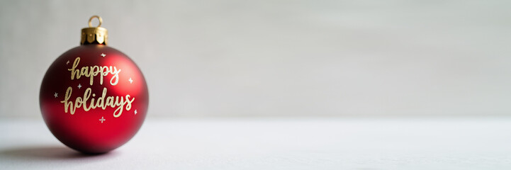 Banner Simple red ball ornament and handwritten “Happy Holidays”, clean Scandinavian design