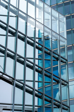 Architecture facade reflection forming a pattern of geometry in a modern glass structure with urban design elements expressed through contemporary style aesthetics