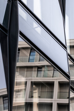 Architecture facade reflection forming a pattern of geometry in a modern glass structure with urban design elements expressed through contemporary style aesthetics