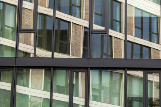 Architecture facade reflection forming a pattern of geometry in a modern glass structure with urban design elements expressed through contemporary style aesthetics