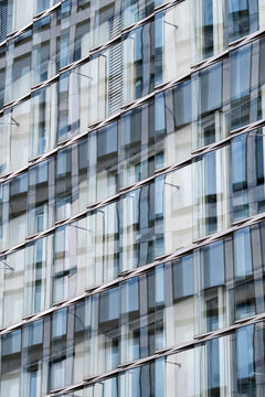 Architecture facade reflection forming a pattern of geometry in a modern glass structure with urban design elements expressed through contemporary style aesthetics