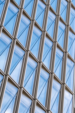 Architecture facade reflection forming a pattern of geometry in a modern glass structure with urban design elements expressed through contemporary style aesthetics