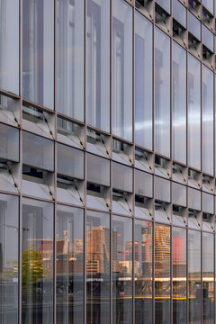 Architecture facade reflection forming a pattern of geometry in a modern glass structure with urban design elements expressed through contemporary style aesthetics