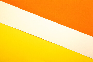 Colored paper background. Yellow, orange and white. Copy space
