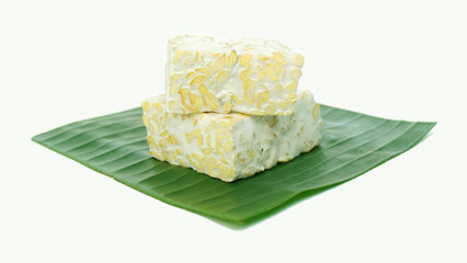 Tempeh or soybean tempeh, a source of vegetable protein made from soybeans that are boiled and given special yeast through a fermentation process until they form a solid on green banana leaves.