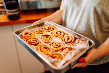 A vibrant berry cake with fresh cupcakes stands in the cozy bakery's window. Fragrant desserts in the coffee shop. Food concept, small business.