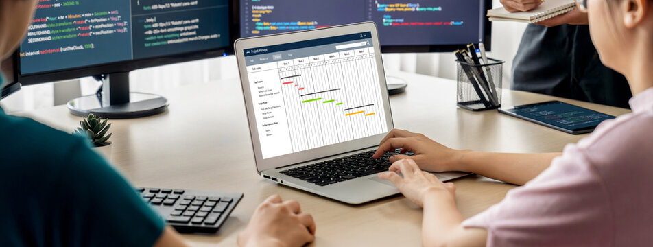Project planning software for brisk business project management on the computer screen showing timeline chart of the team project