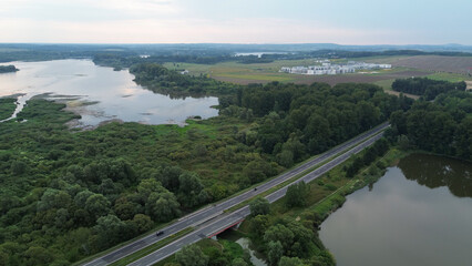 Aerial view of road near river and forest