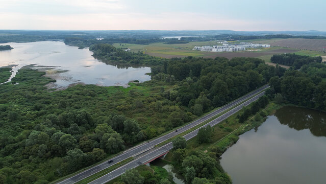 Aerial view of road near river and forest