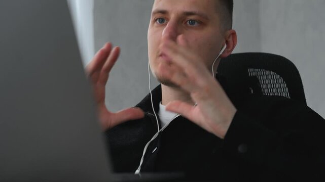 A service center employee communicates with colleagues during an online conference call.
Remote work at a computer.
A call center operator sits at a desk in an office, communicating with clients remot