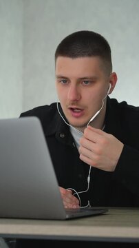 A service center employee communicates with colleagues during an online conference call.
Remote work at a computer.
A call center operator sits at a desk in an office, communicating with clients remot