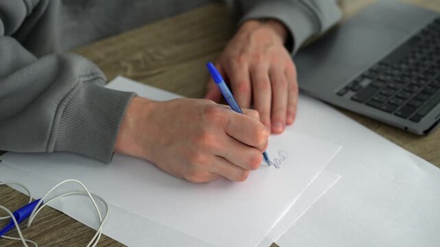 A man fills out paperwork in a bright office.
Signing important documents at a desk.
A male screenwriter sits at his desk with a pen in hand.
Work, writing, office, science, education, screenwriter