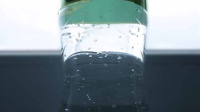 Closeup Blurred Shooting with Bubbles from a Botle with Accidulated Sweet and Fresh Drink.
