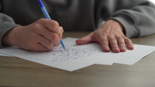 A man fills out paperwork in a bright office.
Signing important documents at a desk.
A male screenwriter sits at his desk with a pen in hand.
Work, writing, office, science, education, screenwriter