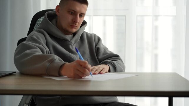 Writing a script at a desk in an office.
A man writes with a pen on a white sheet of paper.
A copy editor writes with a pen in an office.
A man writes a text on paper.
Text, script, documents, editor,